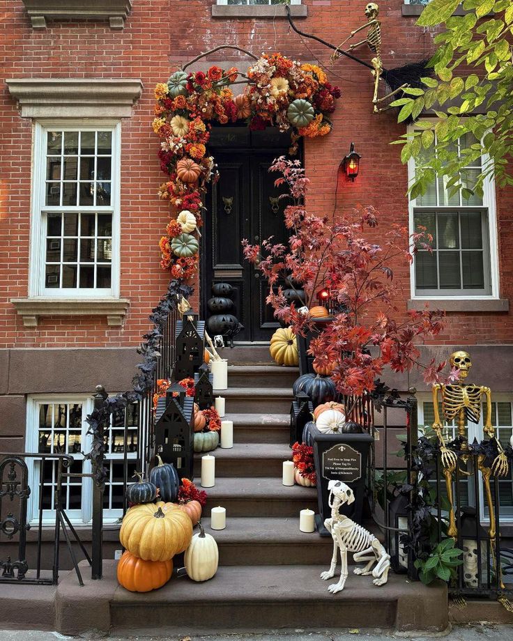 a house decorated for halloween with pumpkins and decorations