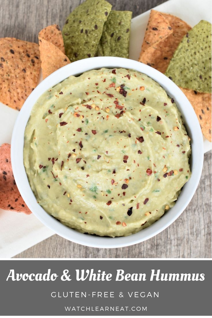 a white bowl filled with guacamole surrounded by tortilla chips and salsa