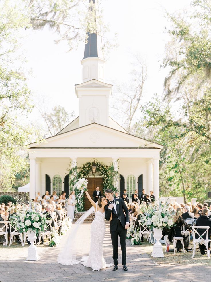 a newly married couple standing in front of a church