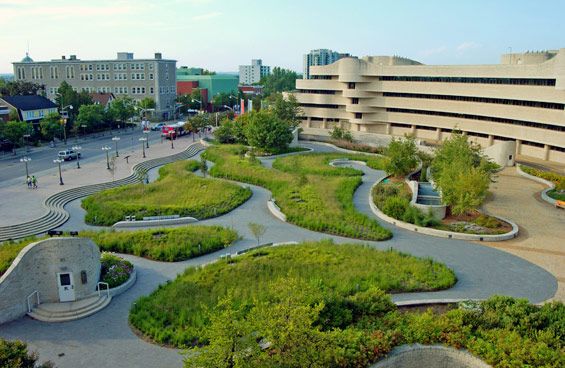 an aerial view of a building with green plants in the foreground