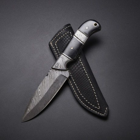 a knife with a leather sheath attached to it