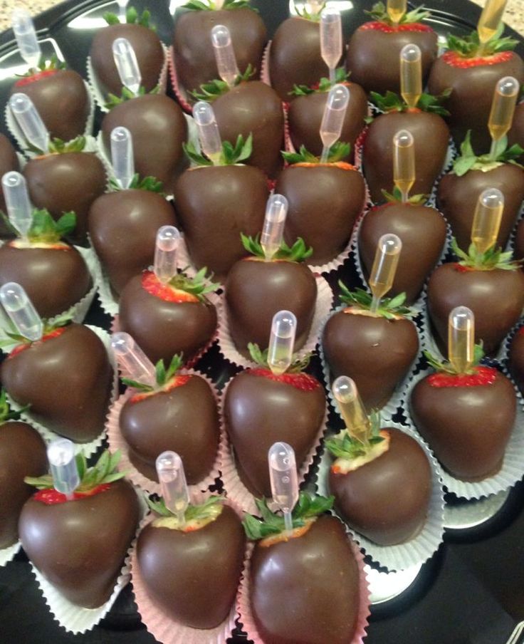 chocolate covered strawberries are arranged in rows