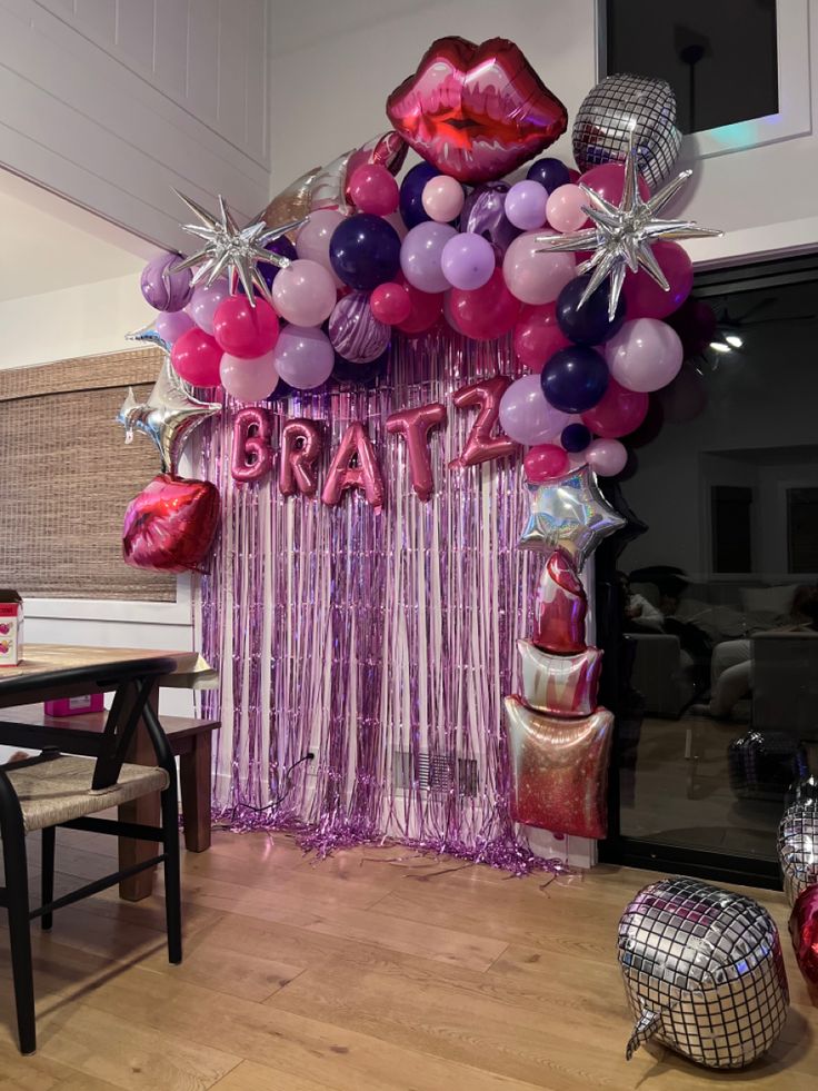 balloons and streamers decorate the entrance to a party