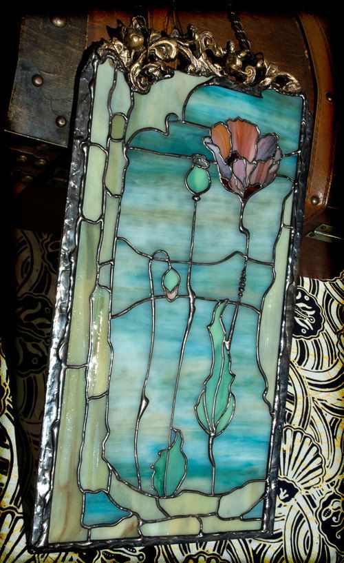 a stained glass window with a flower on it