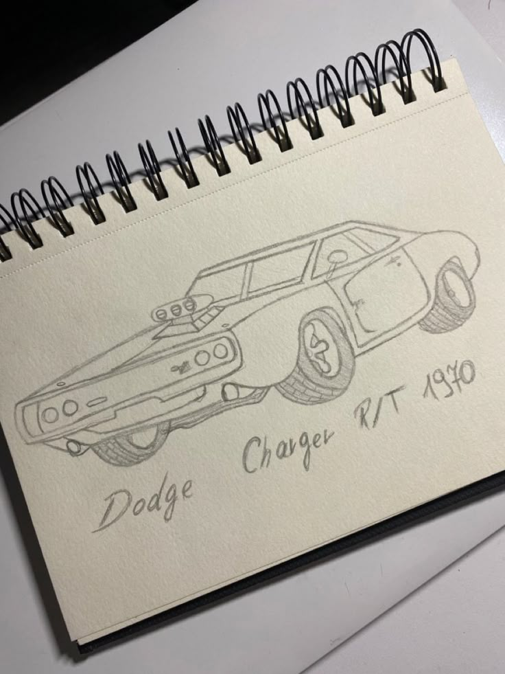 a drawing of a dodge charger r t 1970 on top of a notepad