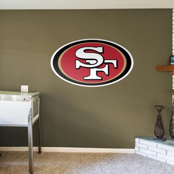 the san francisco logo is mounted on the wall in this room with carpet and furniture