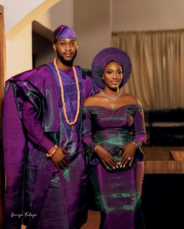 a man and woman dressed in purple standing next to each other