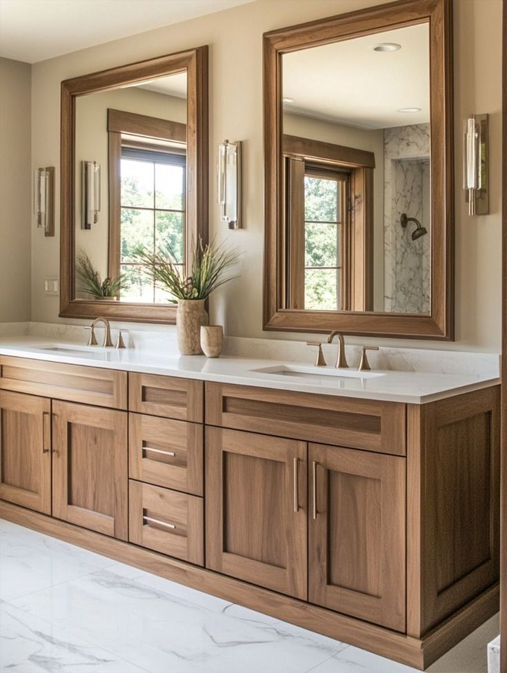 a large bathroom with two sinks and mirrors