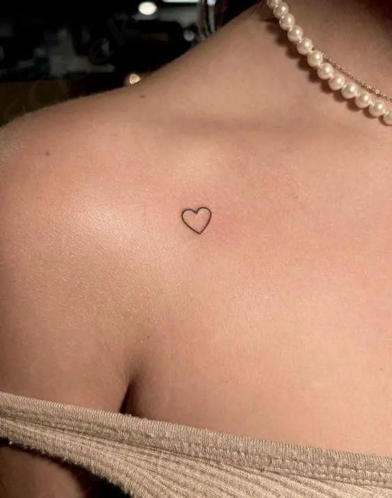 a woman with a heart tattoo on her chest