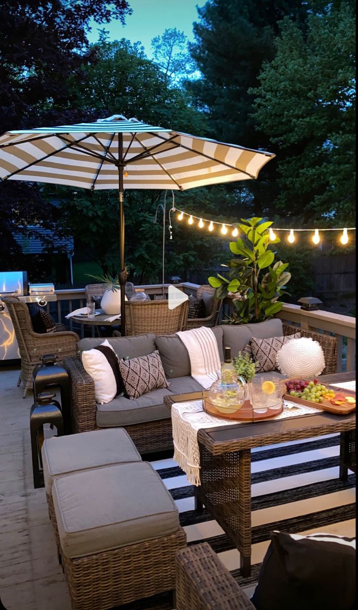 an outdoor patio with wicker furniture and lights