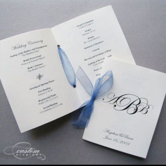 wedding program booklet with blue ribbon and monogramming