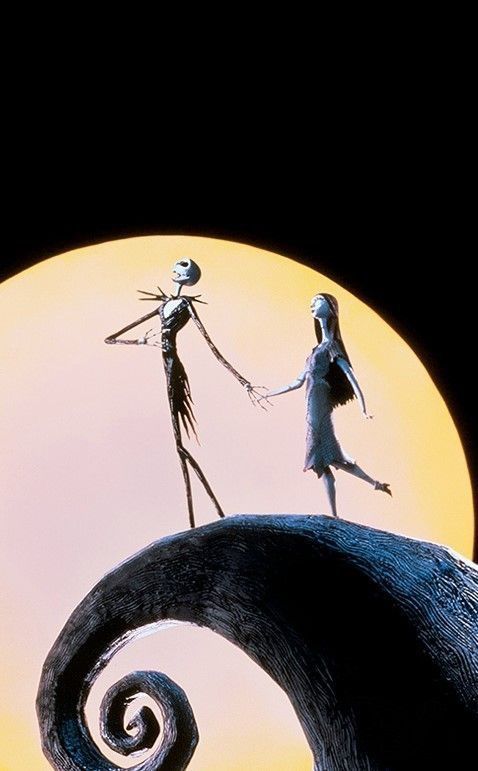 two people dressed as jack and sally from the nightmare before they fell down in front of a full moon