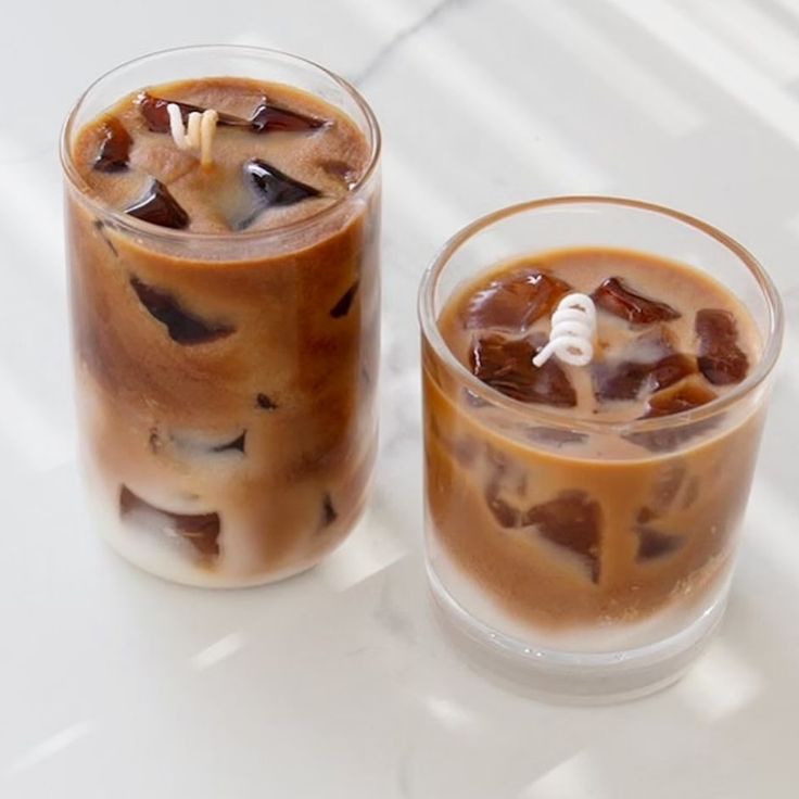 two iced drinks sitting next to each other on a table