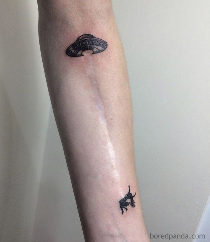 a person with a small tattoo on their arm that has a whale in the water