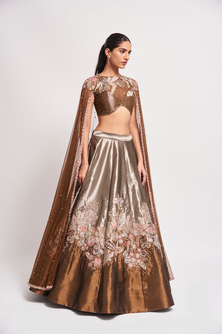 Kinfolk Copper metallic applique embellished tissue MK lehenga with tulle cape blouse. From Aisha Rao's Kinfolk collection. DELIVERY TIMEPlease allow 6-8 weeks for your outfit to arrive. FABRIC DETAILSTissue Professional cleaning only. Metallic Lehenga, Aisha Rao, Cape Blouse, Tulle Cape, Indian Outfits Lehenga, Lehenga Blouse Designs, Indian Dresses Traditional, Lehenga Blouse, Unique Blouse