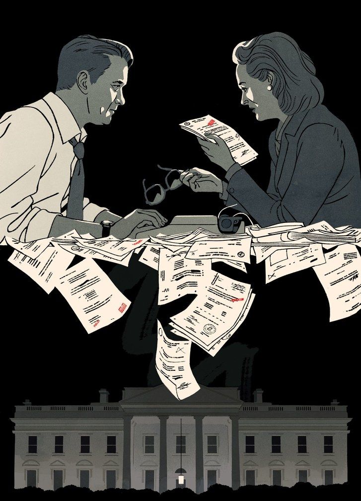 two people sitting at a table with papers flying in the air and one person reading