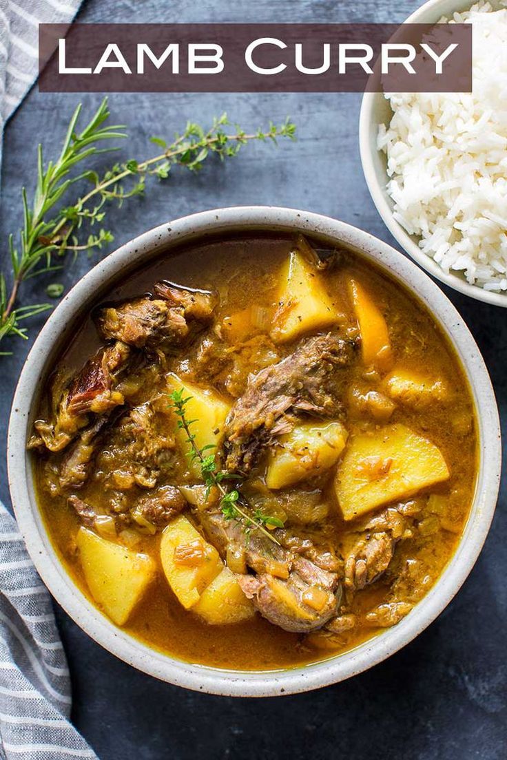 a bowl filled with lamb curry next to rice