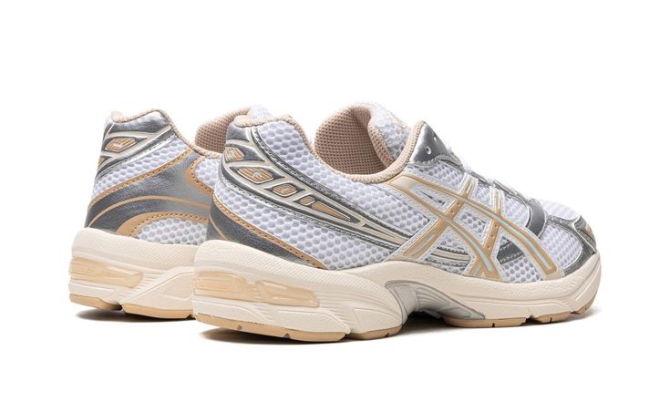 The Women’s ASICS Gel-1130 “Silver/Dune” is a women’s-exclusive colorway of the retro running shoe with a classic look.  Debuted in 2008, the ASICS Gel-1130 was brought back as a lifestyle shoe as part of the Y2K-era trend in sneakers.  On the “Silver/Dune” colorway, the shoe features a versatile color scheme with a white open mesh upper and metallic silver synthetic leather overlays with Dune, or tan, accents.  ASICS’s Gel cushioning technology is embedded within the midsole for all-day comfort Dune Shoes, Retro Running Shoes, Y2k Era, Build A Wardrobe, Stadium Goods, July 1, Asics Gel, Running Shoe, Synthetic Leather