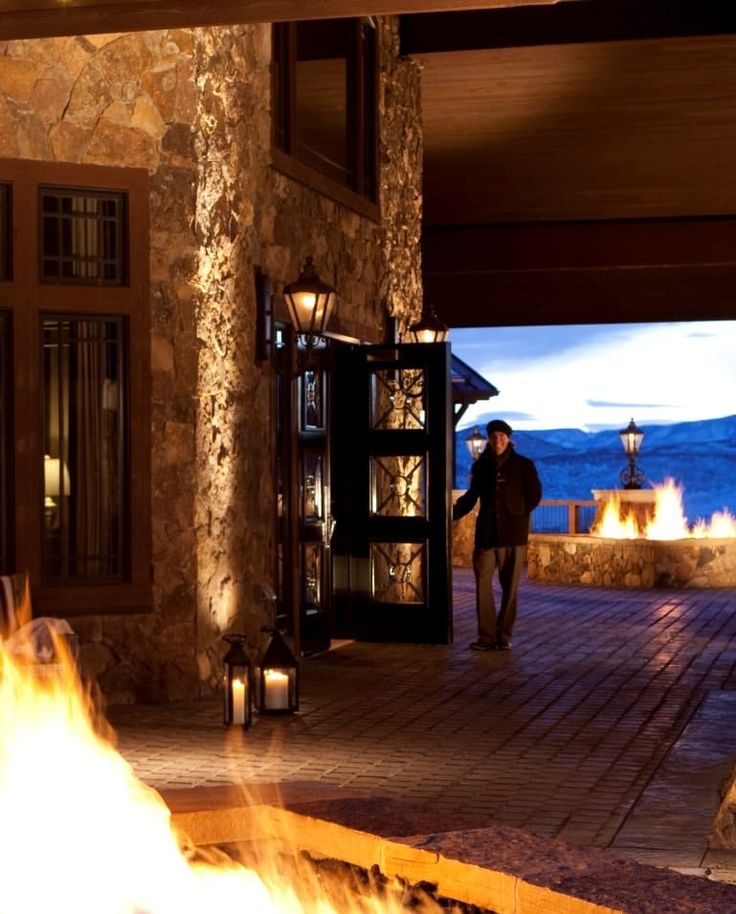 a man standing in front of a fire pit