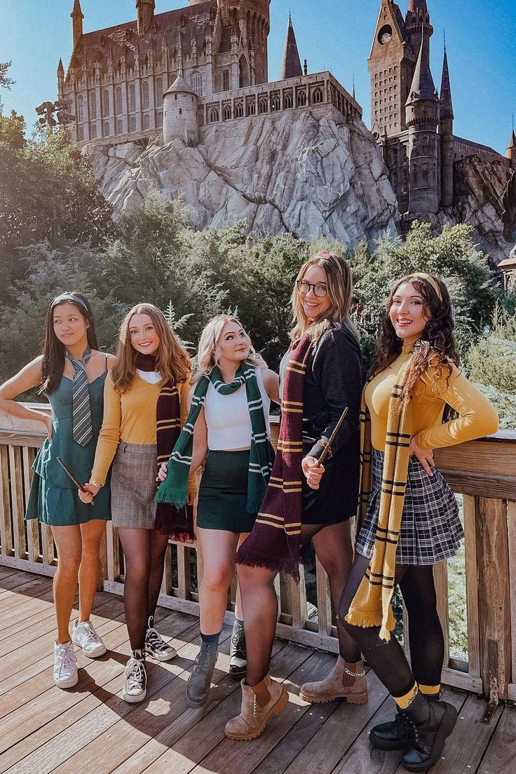 a group of young women standing on top of a wooden deck next to each other