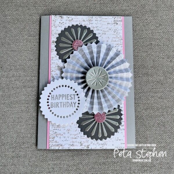 a card with some paper flowers on it