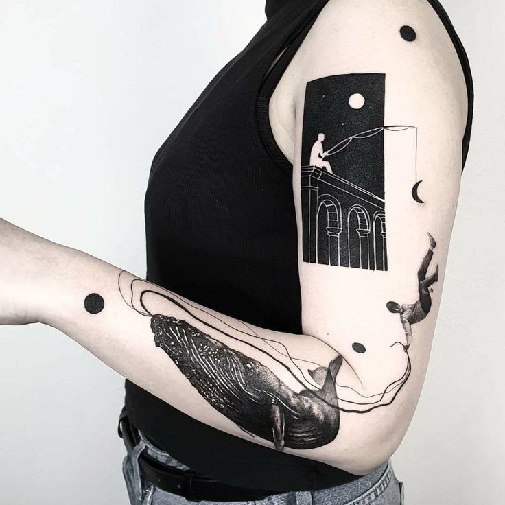 a woman with a black and white tattoo on her arm