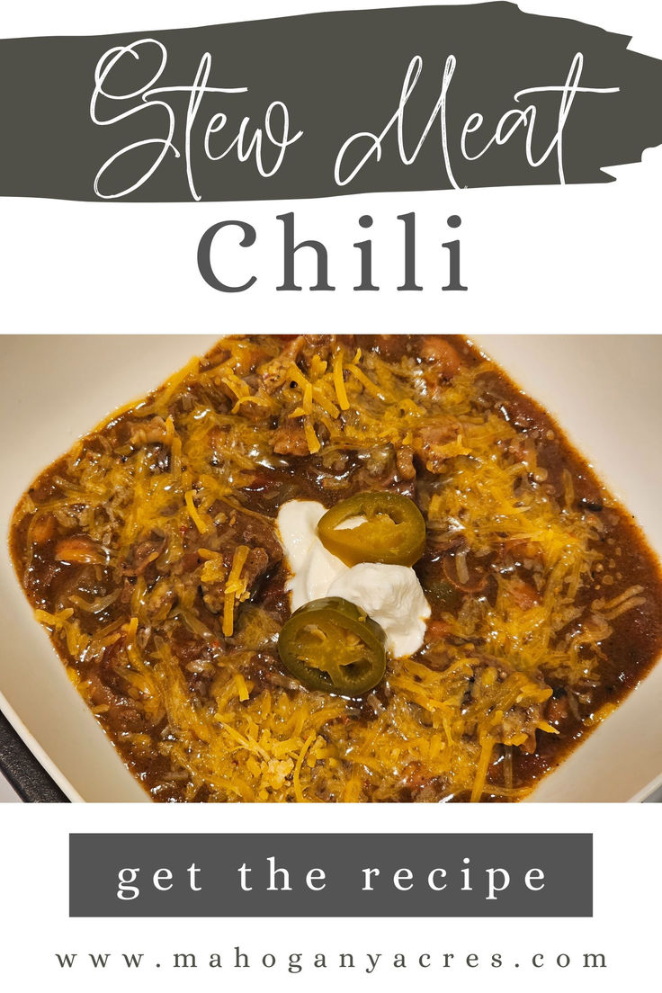 a white plate topped with chili and sour cream