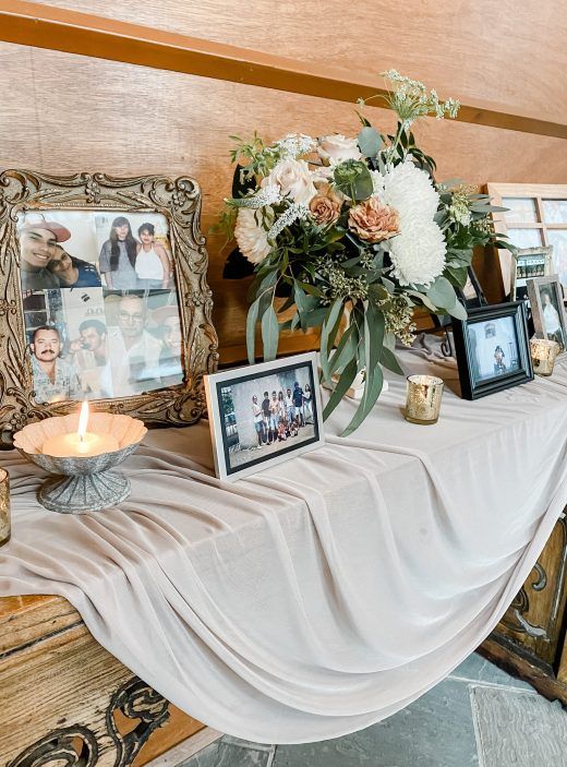 a table with pictures and flowers on it