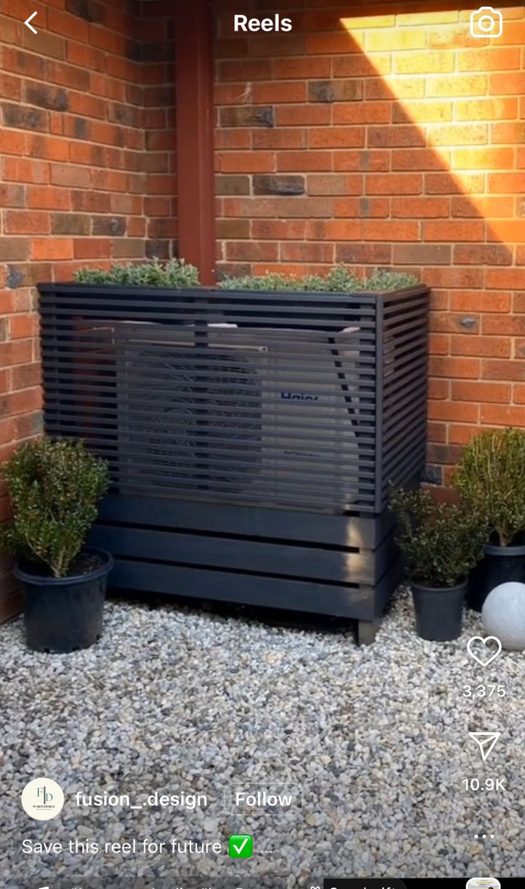 an air conditioner sitting in front of a brick building