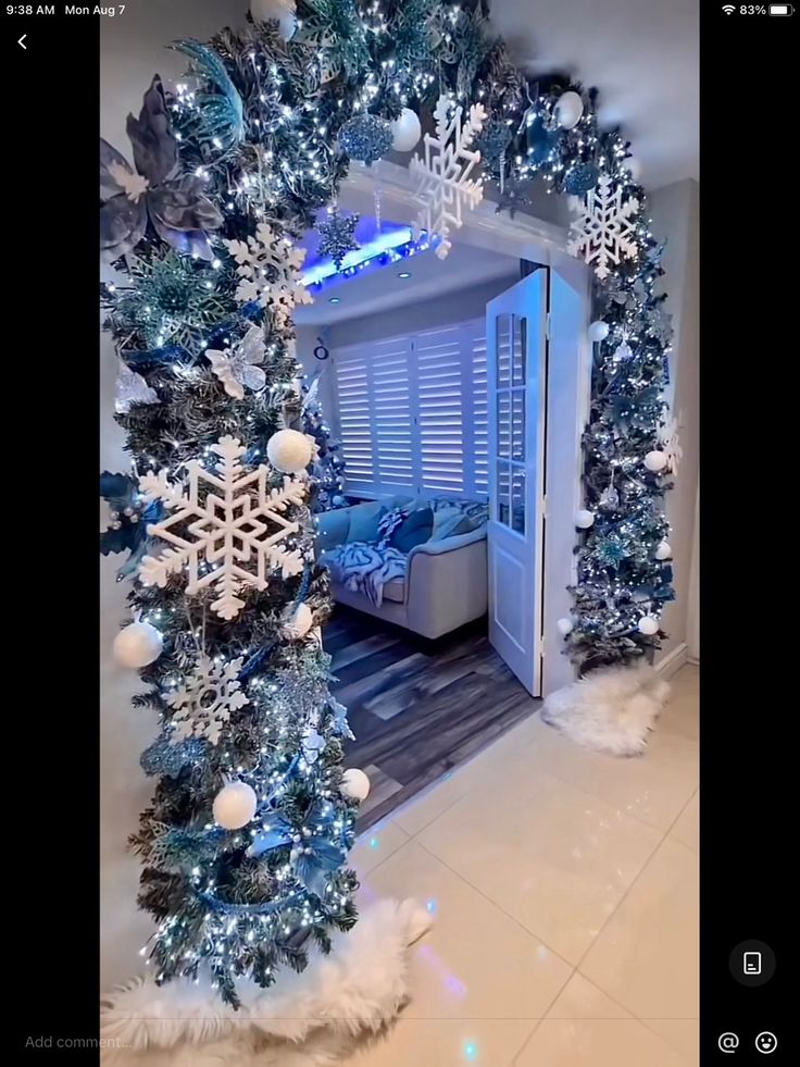 a room decorated for christmas with blue and white decorations