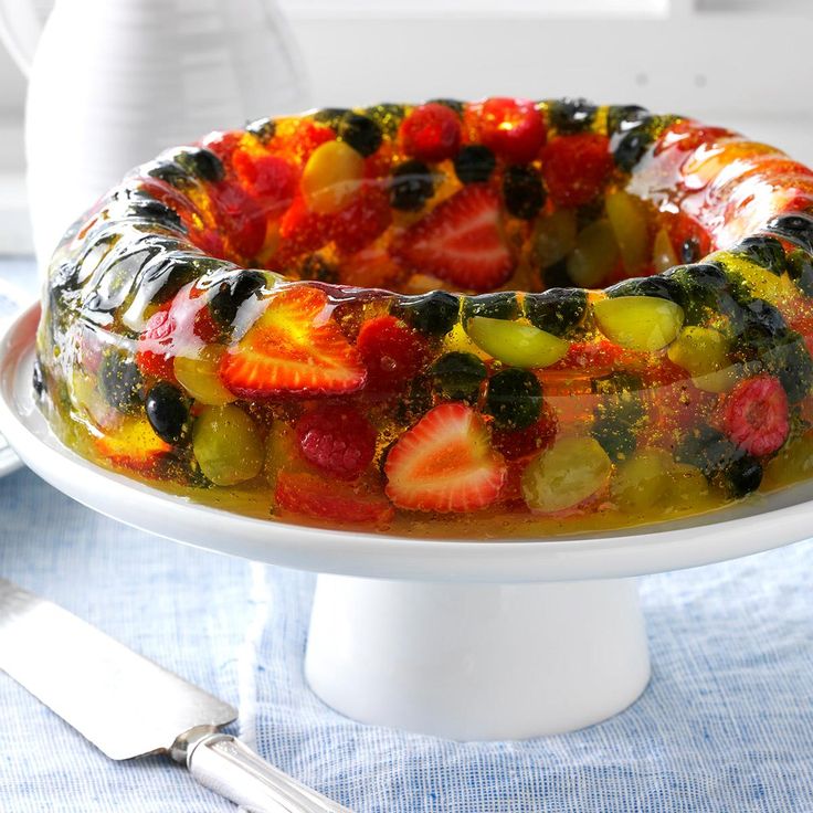 a fruit cake on a white plate with silverware