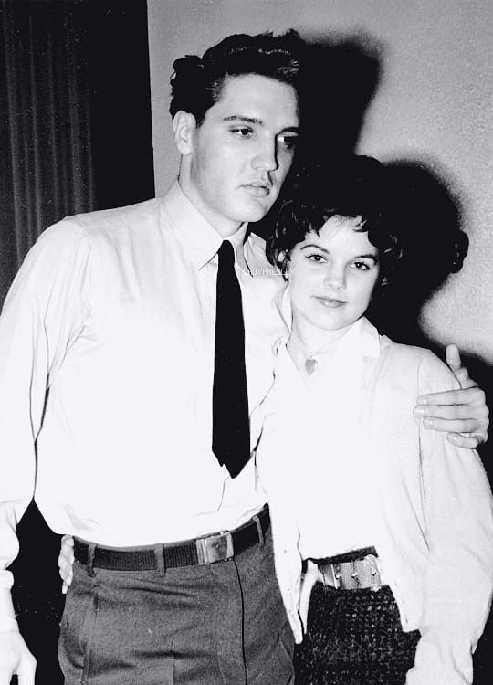 a man and woman standing next to each other