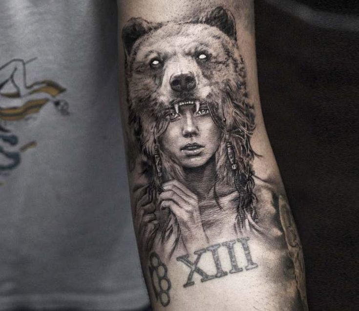 a man with a bear tattoo on his arm