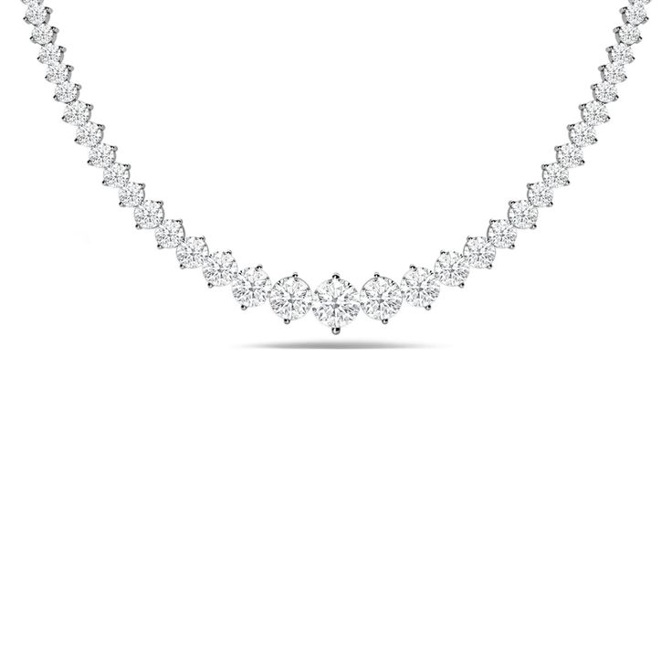 Let this ribbon of diamonds encircle your neck with regal elegance. This tennis necklace features a line of brilliant diamonds meticulously set in two-prong baskets. A larger diamond sits at the center of the strand and gradually tapers in size as it moves away from the center. Anniversary Tennis Necklace In Diamond White With Brilliant Cut, Elegant Baguette Cut Diamond Necklace In Prong Setting, Classic Diamond White Necklaces With Diamond Accents, Timeless Diamond White Necklace With Prong Setting, Fine Jewelry Diamond White Tennis Necklace For Anniversary, Formal Solitaire Diamond Necklace With Baguette Cut, Formal Solitaire Necklace With Baguette Cut Diamond, Bridal Diamond Necklace With Round Prong Setting, Elegant Necklace With Prong Setting And Lab Grown Diamonds