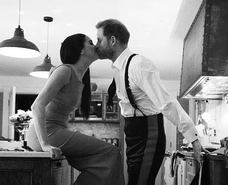 a man and woman kissing in the kitchen