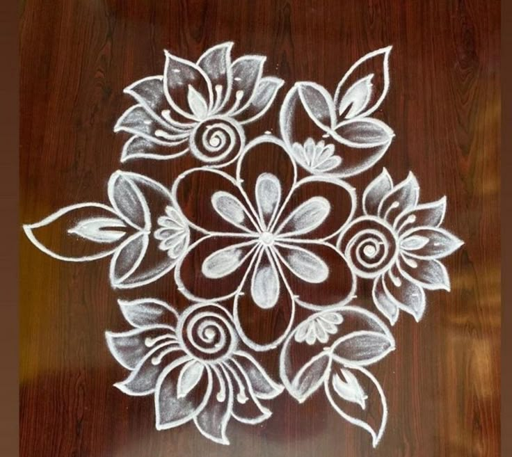 a white flower design on a wooden table