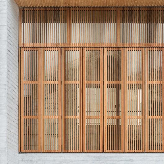 an image of a building with wooden slats on the front and side windows that are closed