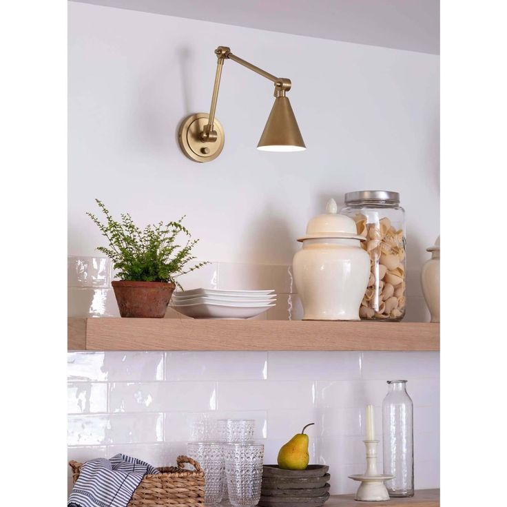 an image of a kitchen shelf with dishes and utensils on it's shelves