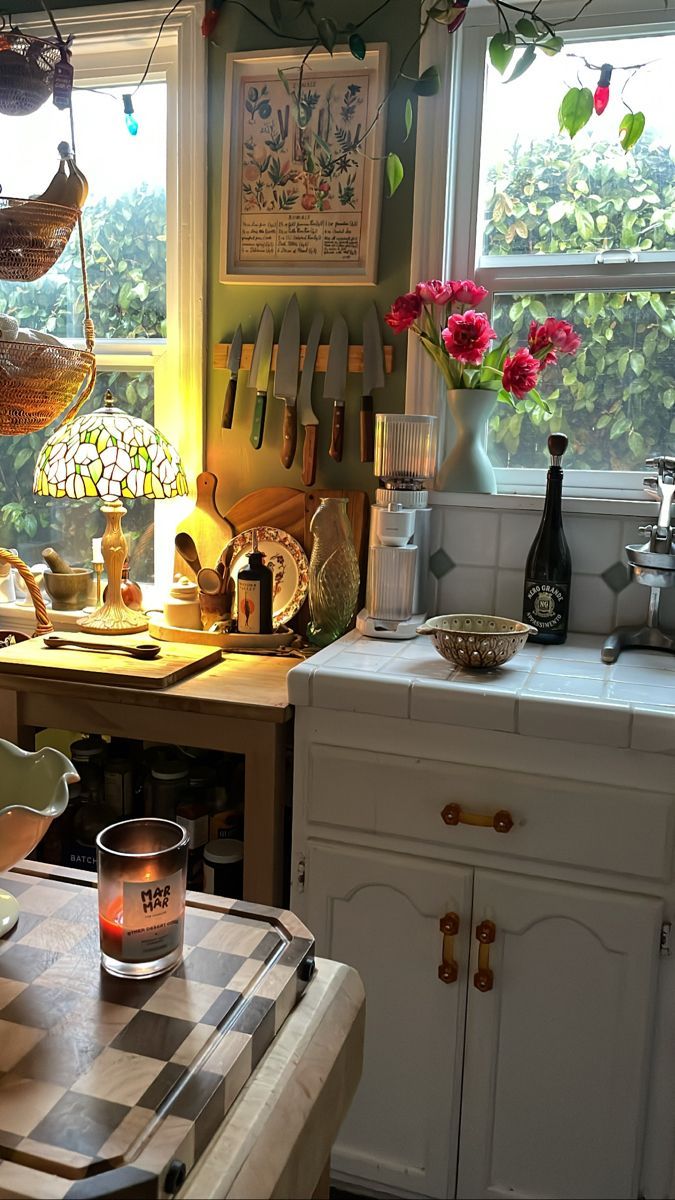 a kitchen filled with lots of clutter and cooking utensils on top of a counter