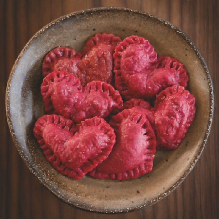 heart shaped pastries in a bowl on a table