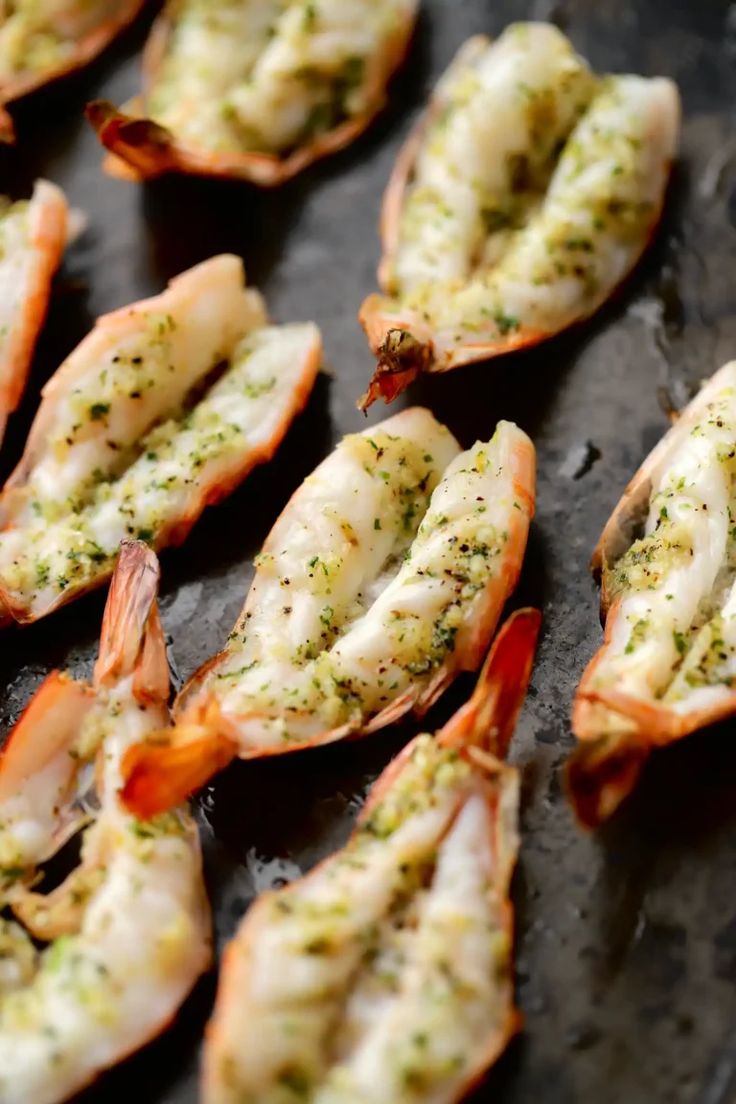 cooked shrimp with herbs and seasoning on a baking sheet, ready to be served