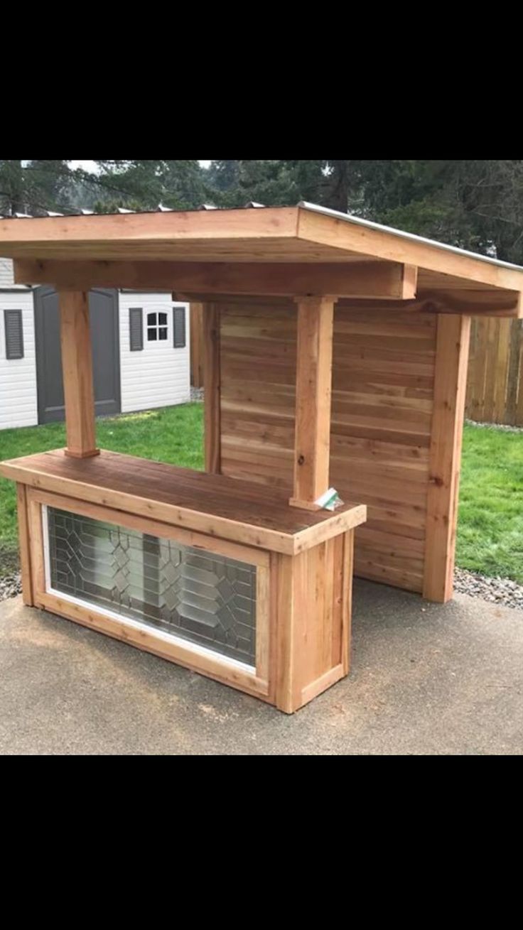 a wooden bench sitting in the middle of a yard