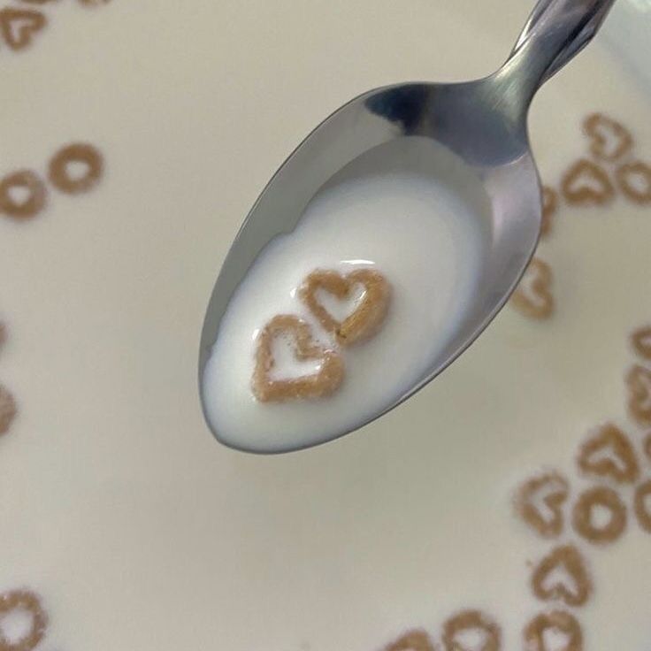 a spoon that has some kind of food on it with the word love written in it