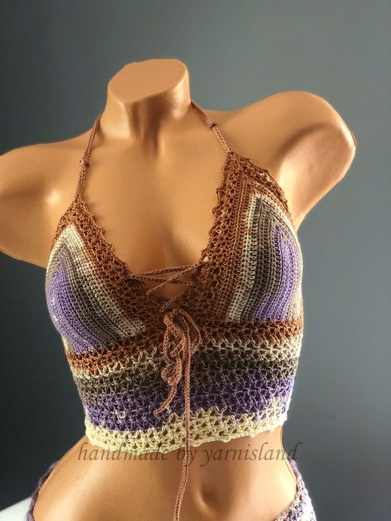 a mannequin wearing a crocheted halter top with ties on it