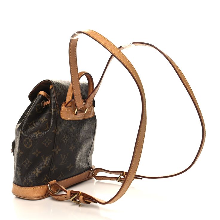 This is the authentic LOUIS VUITTON Monogram Mini Montsouris Backpack. This versatile backpack is crafted of classic monogram coated canvas. The bag features a front zipper pocket, and natural vachetta cowhide leather trim, base, top handle, and adjustable backpack straps. The bag opens with a belt buckle to a cocoa brown fabric interior. Montsouris Backpack, Classic Monogram, Cocoa Brown, Brown Fabric, Backpack Straps, Belt Buckle, Leather Trim, Authentic Louis Vuitton, Cowhide Leather