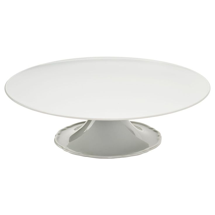 an empty white cake plate on a white background