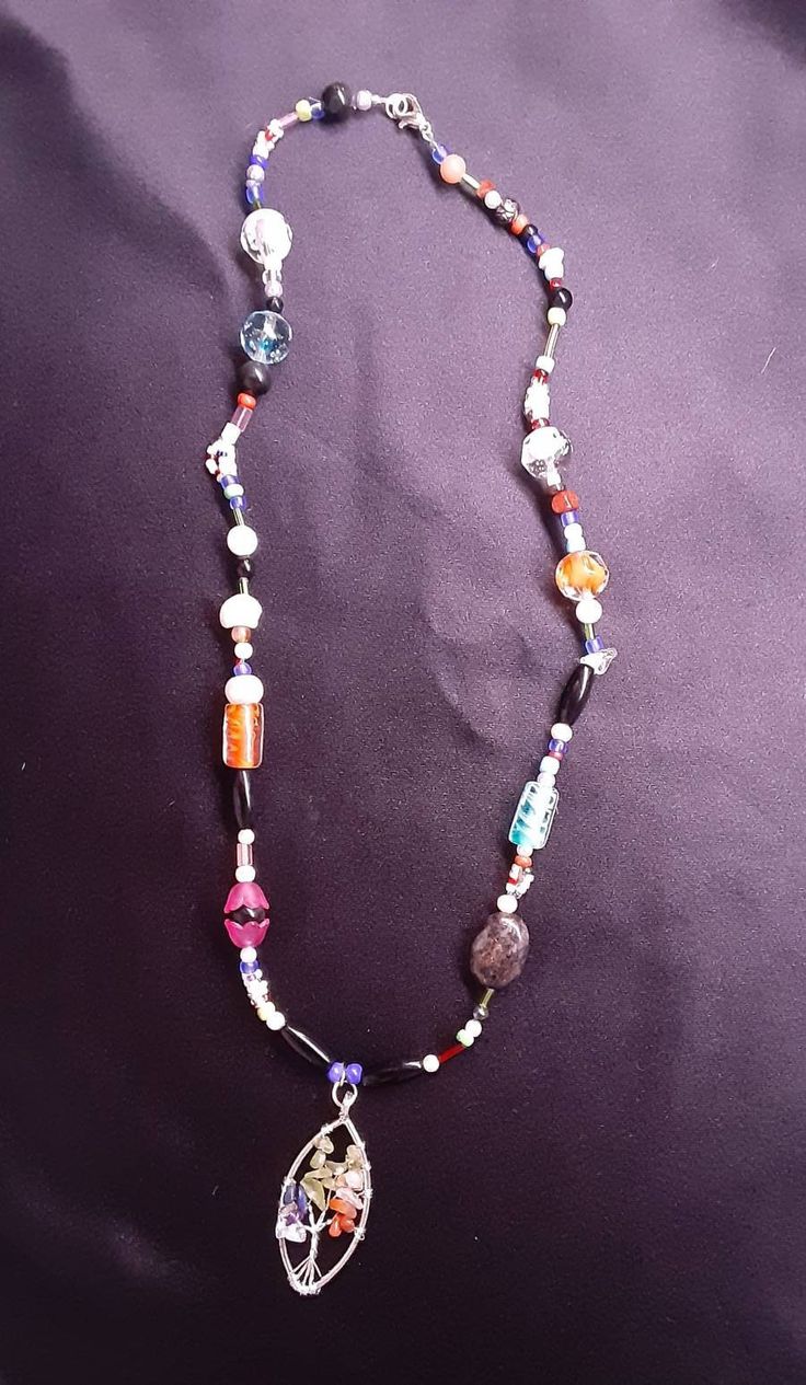 "This necklace  is made of sterling  silver  and glass beads. The pendant is a  colorful  tree of life pendant the colors in the pendant metaphysically reaches the Chakra centers. The beads are a variety  of glass, plastic and shell, citrine, laborite, jasper and amethyst. This necklace is one of a kind and a duplicate has not been made.  Necklace Measurements: Length: 22\" Pendant  Height: 1.4\" If you have any questions or concerns, please do not hesitate to contact our shop. Thank you for you Spiritual Glass Beaded Necklaces With Polished Beads, Spiritual Glass Beaded Necklace With Polished Beads, Multicolor Spiritual Beaded Chain Jewelry, Spiritual Glass Gemstone Beads Jewelry, Spiritual Multicolor Beaded Chain Jewelry, Multicolor Glass Spiritual Jewelry, Colorful Glass Beads Festival Jewelry, Colorful Glass Beads Jewelry For Festival, Spiritual Multicolor Glass Jewelry