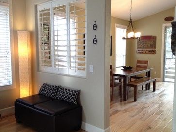 a living room filled with furniture next to a dining room table and window covered in blinds