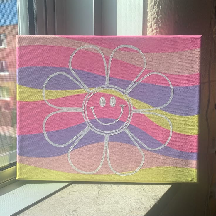 a painted flower sitting on top of a window sill