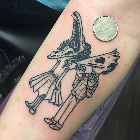 a person with a tattoo on their arm holding a coin and wearing a costumed outfit